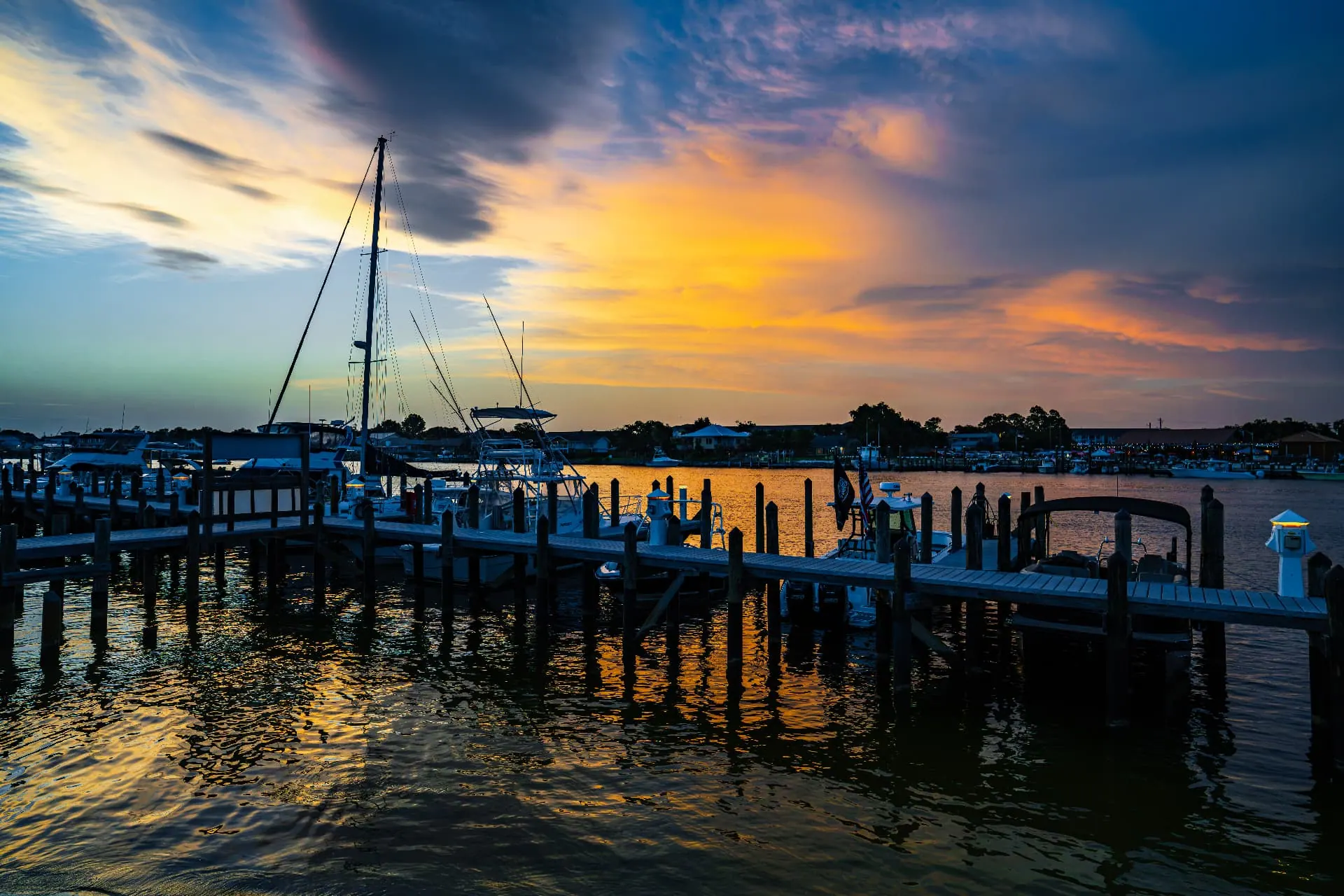 Vibrant sunset over the marina docks and boats at Perdido Key RV Resort